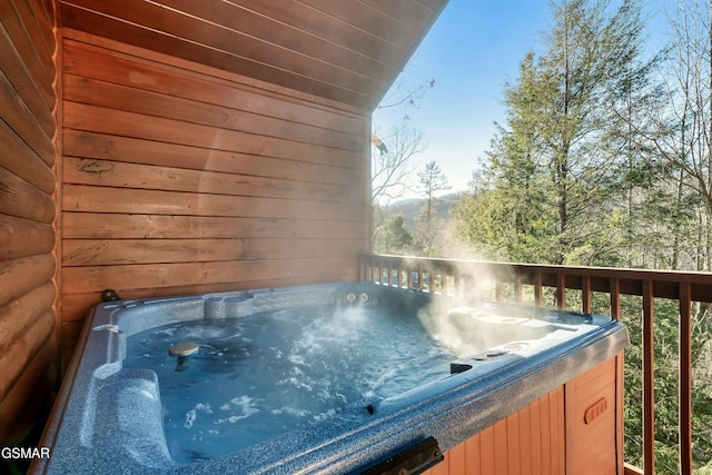 wooden deck featuring a hot tub