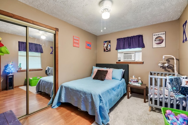2655 Craig Circle Way, Cosby, TN 37722 - bedroom with a closet, a textured ceiling, wood finished floors, and cooling unit