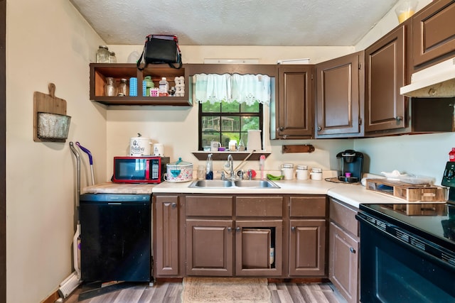 2655 Craig Circle Way, Cosby, TN 37722 - kitchen with black appliances, light wood finished floors, under cabinet range hood, light countertops, and a textured ceiling