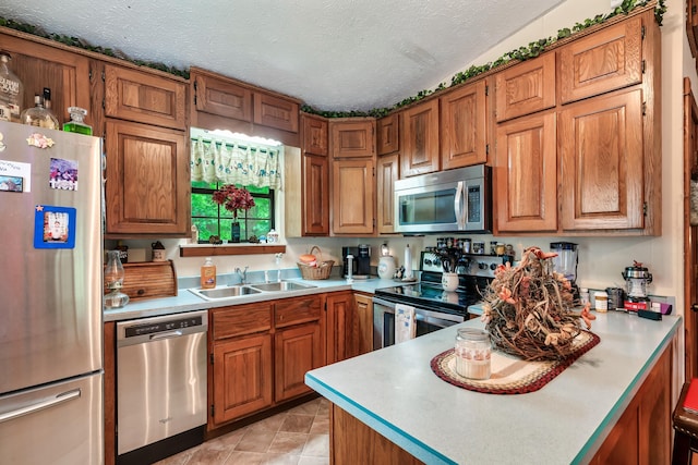 2655 Craig Circle Way, Cosby, TN 37722 - kitchen with appliances with stainless steel finishes, brown cabinets, and a textured ceiling