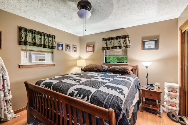 2655 Craig Circle Way, Cosby, TN 37722 - bedroom featuring wood finished floors, cooling unit, a textured ceiling, and a ceiling fan