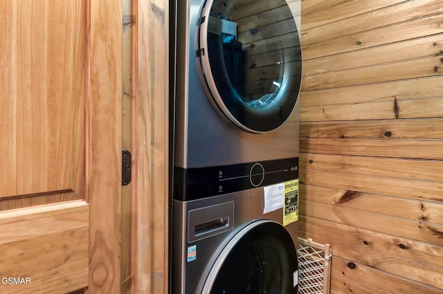 646 Gatlinburg Falls Way, Gatlinburg, TN 37738 - washroom featuring wood walls, stacked washer / drying machine, and laundry area