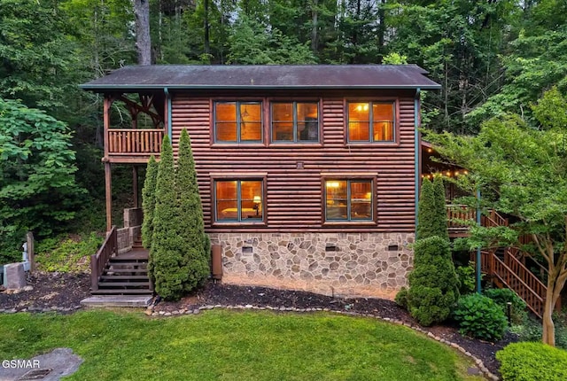 646 Gatlinburg Falls Way, Gatlinburg, TN 37738 - rustic home with a deck, stairway, stone siding, a front lawn, and a forest view