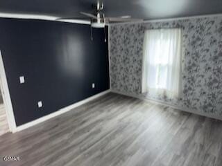 unfurnished room with hardwood / wood-style flooring and ceiling fan