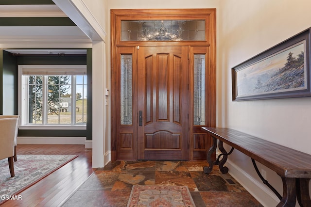 entryway with wood finished floors and baseboards