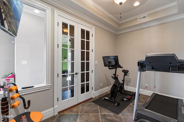 workout area featuring visible vents, baseboards, french doors, crown molding, and a raised ceiling