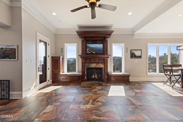 unfurnished living room featuring baseboards, plenty of natural light, ornamental molding, and a fireplace