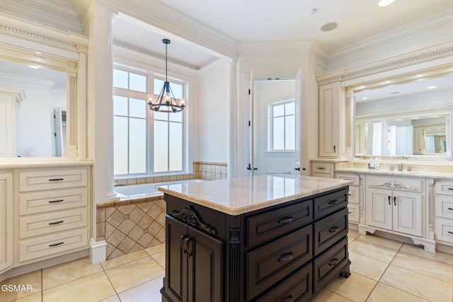 bathroom featuring crown molding, decorative columns, a bathtub, an inviting chandelier, and tile patterned floors