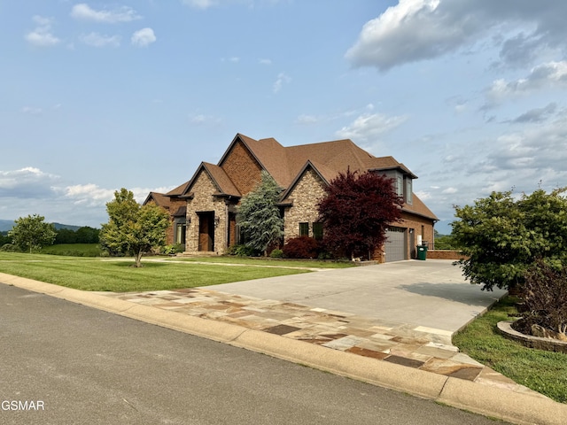 1919 Legend View Ct, Sevierville, TN 37862 - view of front facade with stone siding, concrete driveway, a front lawn, and an attached garage