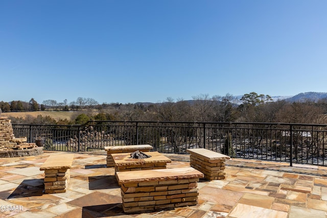 view of patio / terrace featuring an outdoor fire pit