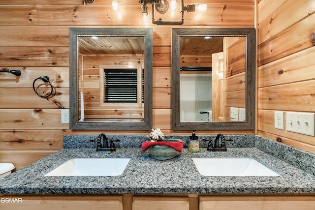 bathroom featuring vanity and wooden walls