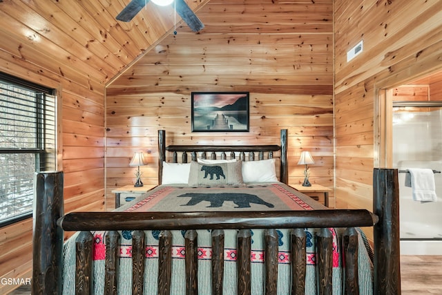 bedroom with lofted ceiling, wood ceiling, and wood walls