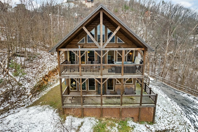 view of snow covered back of property