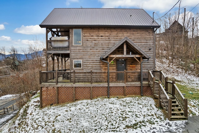 view of snow covered rear of property