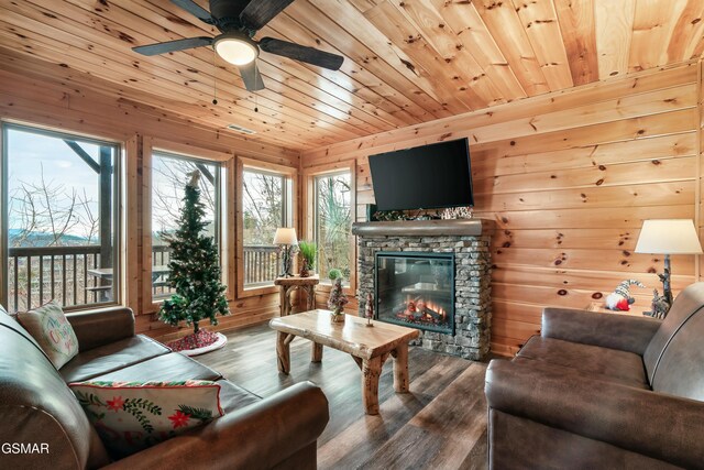 living room with hardwood / wood-style floors, a fireplace, wood walls, ceiling fan, and wooden ceiling