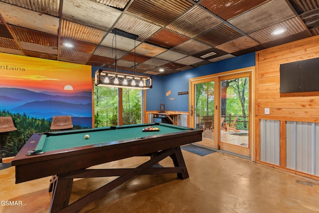 game room featuring wood walls, french doors, and pool table