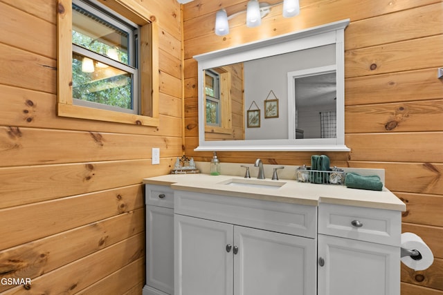 bathroom featuring wood walls and vanity