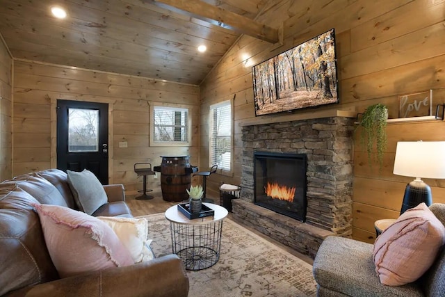 living room featuring vaulted ceiling with beams and wooden walls