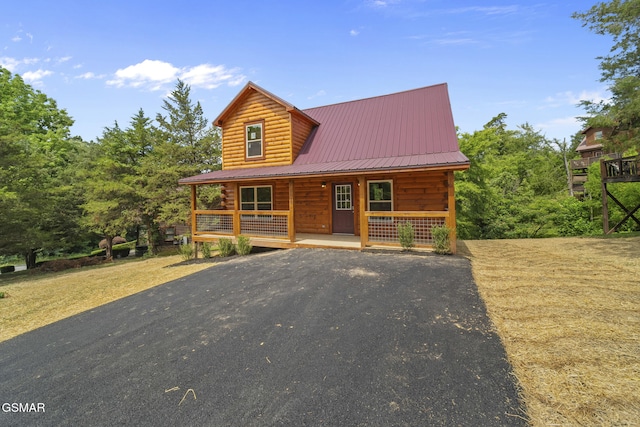 1515 Rainbow Ridge Way, Sevierville, TN 37862 - log-style house with a porch, a metal roof, and driveway
