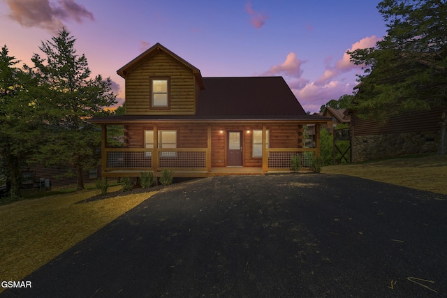 1515 Rainbow Ridge Way, Sevierville, TN 37862 - log-style house featuring covered porch, log siding, a metal roof, and asphalt driveway