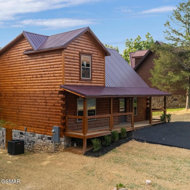 1515 Rainbow Ridge Way, Sevierville, TN 37862 - back of house featuring covered porch, a metal roof, and a lawn