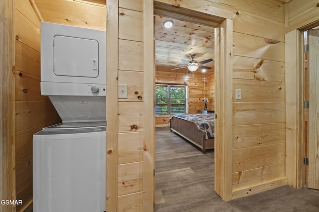 1515 Rainbow Ridge Way, Sevierville, TN 37862 - washroom featuring stacked washer / drying machine, wooden walls, ceiling fan, and wood finished floors