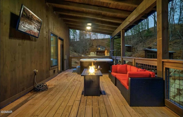 wooden terrace featuring an outdoor living space with a fire pit
