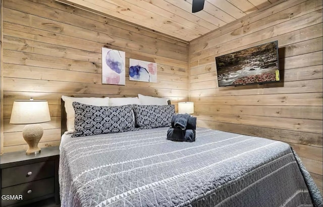 bedroom with wood ceiling and wood walls