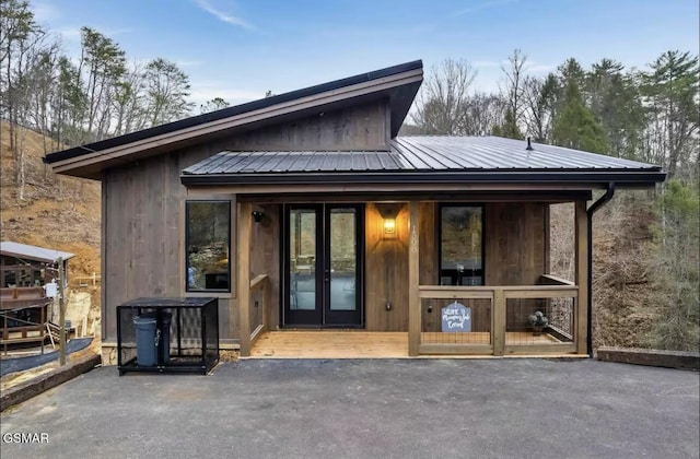 back of property featuring metal roof and french doors