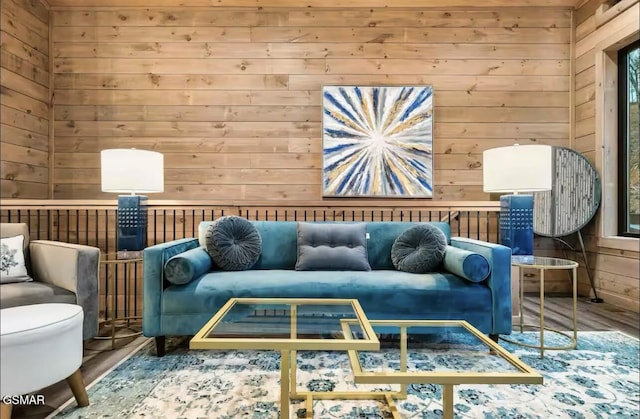 living area with wooden walls and wood finished floors