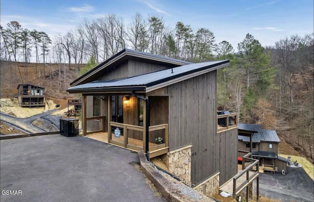 rustic home with stone siding and metal roof