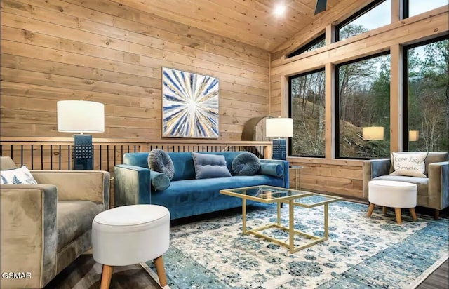 living area with wood ceiling, wood walls, lofted ceiling, and wood finished floors