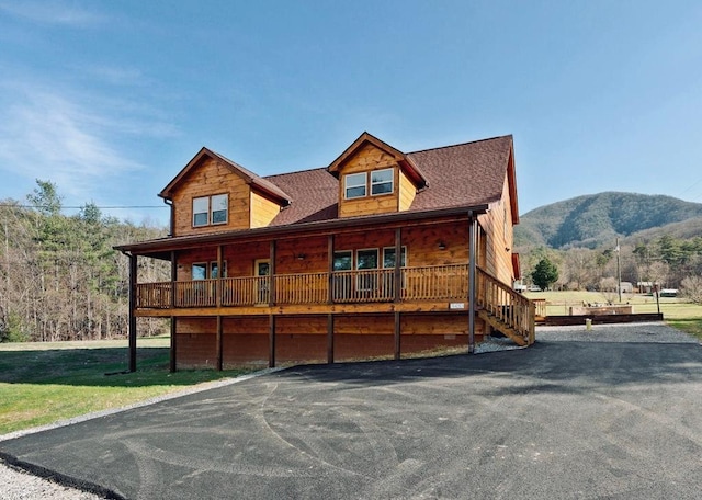 log cabin with a mountain view and a front yard