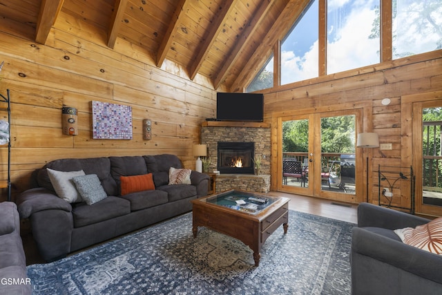 living room featuring beam ceiling, high vaulted ceiling, wood walls, and wood ceiling