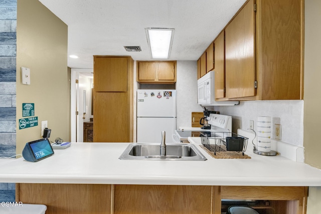 kitchen featuring white appliances and sink