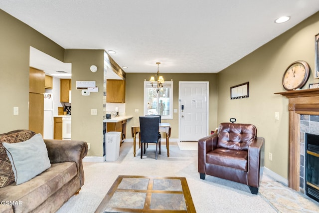 living room featuring light colored carpet, a stone fireplace, and a notable chandelier