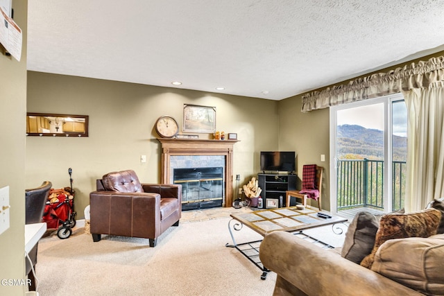 carpeted living room with a textured ceiling and a tiled fireplace