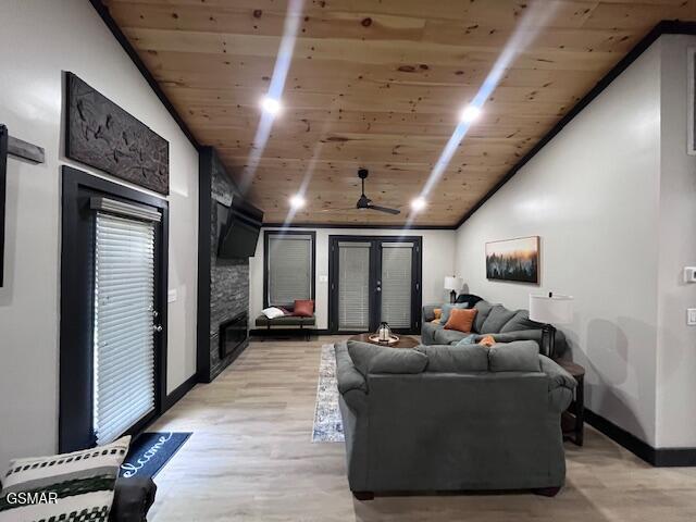 2359 Grassy Branch Rd, Sevierville, TN 37876 - living area featuring a fireplace, wood ceiling, lofted ceiling, light wood-style floors, and french doors
