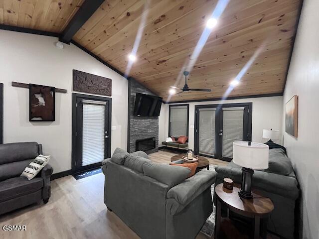 2359 Grassy Branch Rd, Sevierville, TN 37876 - living room featuring wood ceiling, light wood-style floors, a stone fireplace, and a ceiling fan