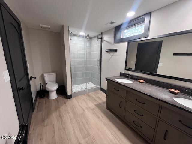 2359 Grassy Branch Rd, Sevierville, TN 37876 - bathroom with a stall shower, wood finished floors, and double vanity