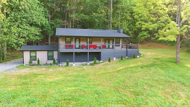2359 Grassy Branch Rd, Sevierville, TN 37876 - view of front of house featuring a front yard, a metal roof, a chimney, and a wooded view
