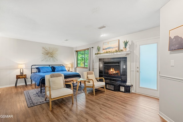 1452 N Arbon Ln, Gatlinburg, TN 37738 - bedroom featuring wood finished floors, a tile fireplace, and baseboards