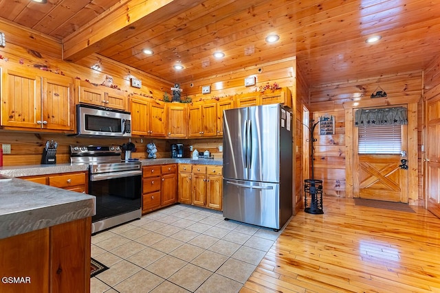 655 Stockton Dr, Sevierville, TN 37876 - kitchen with stainless steel appliances, wooden ceiling, recessed lighting, brown cabinets, and wooden walls