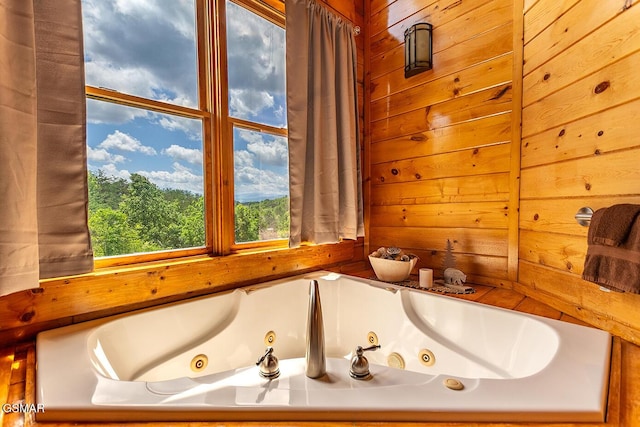 655 Stockton Dr, Sevierville, TN 37876 - full bathroom featuring a jetted tub and wood walls