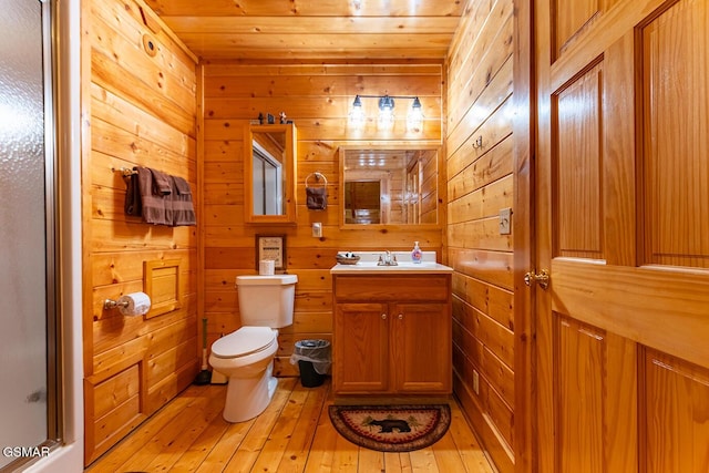 655 Stockton Dr, Sevierville, TN 37876 - full bathroom featuring toilet, wood walls, vanity, hardwood / wood-style floors, and wood ceiling