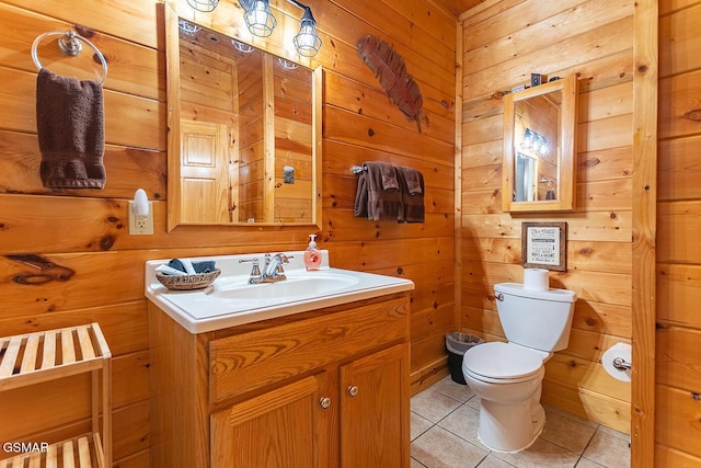 655 Stockton Dr, Sevierville, TN 37876 - half bathroom featuring tile patterned floors, toilet, vanity, and wooden walls