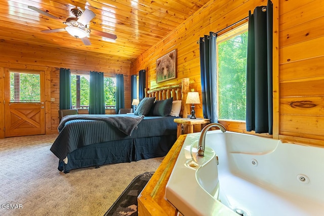 655 Stockton Dr, Sevierville, TN 37876 - carpeted bedroom with wood walls, lofted ceiling, and wooden ceiling