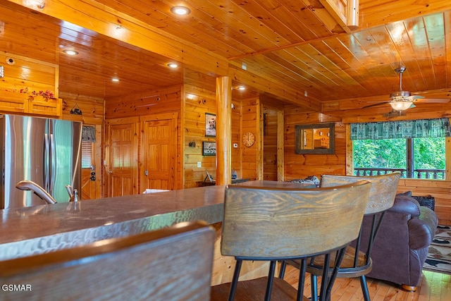 655 Stockton Dr, Sevierville, TN 37876 - indoor bar with freestanding refrigerator, wood ceiling, hardwood / wood-style floors, wooden walls, and a ceiling fan