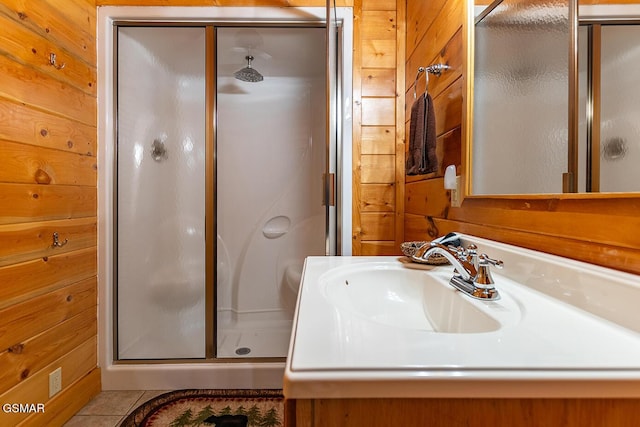 655 Stockton Dr, Sevierville, TN 37876 - full bath featuring wood walls, a stall shower, vanity, and tile patterned floors