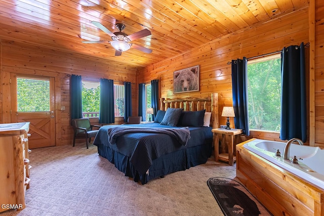 655 Stockton Dr, Sevierville, TN 37876 - bedroom featuring wooden walls, light colored carpet, wooden ceiling, and a ceiling fan